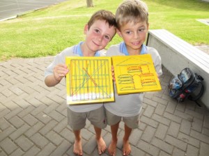 Kayden and Jacob:  Mathematicians at Work. Exploring shapes with the geo boards.